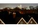 Nighttime view of city buildings with shining lights from rooftop featuring visible chimneys and house roofs at 711 E 16Th St, Indianapolis, IN 46202