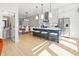 Modern kitchen with a large island, stainless steel appliances, and open layout to dining area at 711 E 16Th St, Indianapolis, IN 46202
