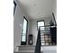 Landing featuring black railings, carpeted floor, modern lantern, and access to an outdoor patio at 711 E 16Th St, Indianapolis, IN 46202