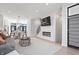 Open-concept living space with modern fireplace, TV, dining area, and large windows at 711 E 16Th St, Indianapolis, IN 46202