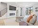 Bright living room showcasing a modern fireplace, mounted TV, sleek staircase and hardwood floors at 711 E 16Th St, Indianapolis, IN 46202