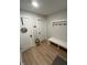Mud room with white bench, coat rack, and wood floors offers a practical entryway at 711 E 16Th St, Indianapolis, IN 46202