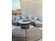 Inviting outdoor seating area featuring a fire pit table and comfortable, cushioned sectional sofa and ottomans at 711 E 16Th St, Indianapolis, IN 46202
