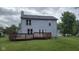 Back exterior of home featuring light blue siding, a deck, and a well-maintained yard at 7168 Camwell Dr, Indianapolis, IN 46268