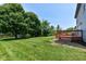 Expansive backyard featuring a large deck, mature trees, and a storage shed at 7168 Camwell Dr, Indianapolis, IN 46268