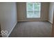 Cozy bedroom featuring plush carpeting and a bright window, creating a comfortable and inviting atmosphere at 7168 Camwell Dr, Indianapolis, IN 46268