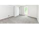 Bright bedroom featuring plush gray carpeting, a closet and a window providing natural light at 7168 Camwell Dr, Indianapolis, IN 46268