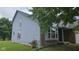 Home exterior featuring light blue siding, brick facade, and a landscaped yard at 7168 Camwell Dr, Indianapolis, IN 46268