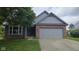 Charming home featuring a brick and siding facade, a well-manicured lawn, and an attached two-car garage at 7168 Camwell Dr, Indianapolis, IN 46268