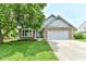 Charming brick and siding home with a well-manicured lawn and a two-car garage at 7168 Camwell Dr, Indianapolis, IN 46268