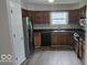 Well-equipped kitchen with stainless steel appliances, dark countertops, and ample cabinet space at 7168 Camwell Dr, Indianapolis, IN 46268