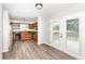 Kitchen with wood cabinets, black appliances, hard surface floors, and access to a deck at 7168 Camwell Dr, Indianapolis, IN 46268