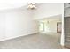 Bright, neutral colored living room with high ceilings, plush carpeting, and access to the staircase at 7168 Camwell Dr, Indianapolis, IN 46268