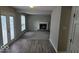 Open-concept living area with a cozy fireplace, plush carpeting, and natural light from the windows at 7168 Camwell Dr, Indianapolis, IN 46268