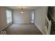 Cozy living room featuring plush carpeting, large windows, and neutral walls at 7168 Camwell Dr, Indianapolis, IN 46268