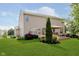 View of backyard showcasing a patio with umbrella, lush lawn, and tasteful landscaping at 7193 Wythe Dr, Noblesville, IN 46062
