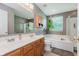 The bathroom features a bathtub, walk-in shower, double vanity, and a large window overlooking the exterior of the property at 7193 Wythe Dr, Noblesville, IN 46062