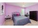 Purple bedroom with a black iron bed frame, a chandelier, and a dresser at 7193 Wythe Dr, Noblesville, IN 46062