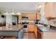 Bright kitchen features stainless steel appliances, wood cabinets, modern lighting, and a sink overlooking the backyard at 7193 Wythe Dr, Noblesville, IN 46062