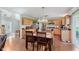 A well-lit kitchen featuring light wood cabinets, stainless steel appliances, and a dining area with a wooden table and chairs at 7193 Wythe Dr, Noblesville, IN 46062
