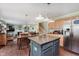 Open-concept kitchen featuring an island, stainless steel appliances, and a dining area, flowing into the living space at 7193 Wythe Dr, Noblesville, IN 46062