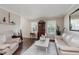 Bright living room with hardwood floors, comfortable seating, and a decorative hutch at 7193 Wythe Dr, Noblesville, IN 46062