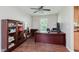 Functional home office featuring a large desk, storage cabinets, and laminate floors at 7193 Wythe Dr, Noblesville, IN 46062