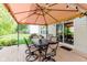 Enjoy outdoor dining under a large umbrella on this home's wooden deck with patio furniture at 7193 Wythe Dr, Noblesville, IN 46062