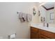 Cozy powder room featuring a wood vanity, decorative mirror, and neutral wall color at 7193 Wythe Dr, Noblesville, IN 46062