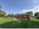 A brick home features a large backyard and deck with a porch swing at 7346 E Buddy Ln, Camby, IN 46113