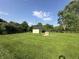 Spacious backyard with green lawn and storage shed under a sunny sky at 7346 E Buddy Ln, Camby, IN 46113