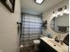 Bathroom featuring modern fixtures, including a round mirror, stylish vanity, and patterned shower curtain at 7346 E Buddy Ln, Camby, IN 46113