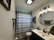 Bathroom featuring modern fixtures, including a round mirror, stylish vanity, and patterned shower curtain at 7346 E Buddy Ln, Camby, IN 46113