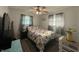 Bright bedroom features floral bedding, a ceiling fan, and plenty of natural light at 7346 E Buddy Ln, Camby, IN 46113