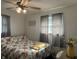 Bright bedroom features floral bedding, a ceiling fan, and plenty of natural light at 7346 E Buddy Ln, Camby, IN 46113