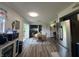 Bright dining area with wood-look floors and a view of the laundry area and a sliding door to the backyard at 7346 E Buddy Ln, Camby, IN 46113