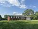 Charming one-story brick home with a well-manicured lawn and a convenient attached garage at 7346 E Buddy Ln, Camby, IN 46113