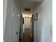 Hallway with white walls and doors, and wood-look flooring at 7346 E Buddy Ln, Camby, IN 46113