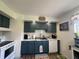 Charming kitchen with blue cabinets, white subway tile backsplash and stainless steel appliances at 7346 E Buddy Ln, Camby, IN 46113