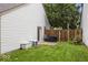 Fenced backyard features a small patio with seating and grill with grass lawn at 7743 Waterwood Dr, Indianapolis, IN 46214
