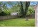 Spacious backyard features a stone firepit, privacy fence, mature trees, and a green lawn at 7743 Waterwood Dr, Indianapolis, IN 46214