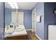 Light blue bathroom with single sink vanity. Tile floors at 7743 Waterwood Dr, Indianapolis, IN 46214