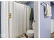 Light blue bathroom with shower and toilet. Tile floors at 7743 Waterwood Dr, Indianapolis, IN 46214