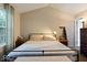 Neutral bedroom with vaulted ceiling and large bed. Carpeted floors at 7743 Waterwood Dr, Indianapolis, IN 46214