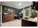 Bedroom with dark olive green walls, brown carpet, and large dresser at 7743 Waterwood Dr, Indianapolis, IN 46214