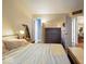 Bedroom with vaulted ceiling, large bed, and dresser. Carpeted floors at 7743 Waterwood Dr, Indianapolis, IN 46214