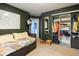 Green bedroom with closet and daybed along wall. Carpeted floors at 7743 Waterwood Dr, Indianapolis, IN 46214