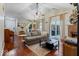 Open-concept living room featuring hardwood floors, fireplace, and access to dining area and kitchen at 7743 Waterwood Dr, Indianapolis, IN 46214