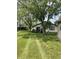 Expansive backyard featuring a well-maintained lawn and a patio area, surrounded by mature trees at 7950 Eagle Valley Pass, Indianapolis, IN 46214