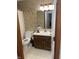 This is a bathroom that features a toilet, vanity and shower with floral print wallpaper at 7950 Eagle Valley Pass, Indianapolis, IN 46214